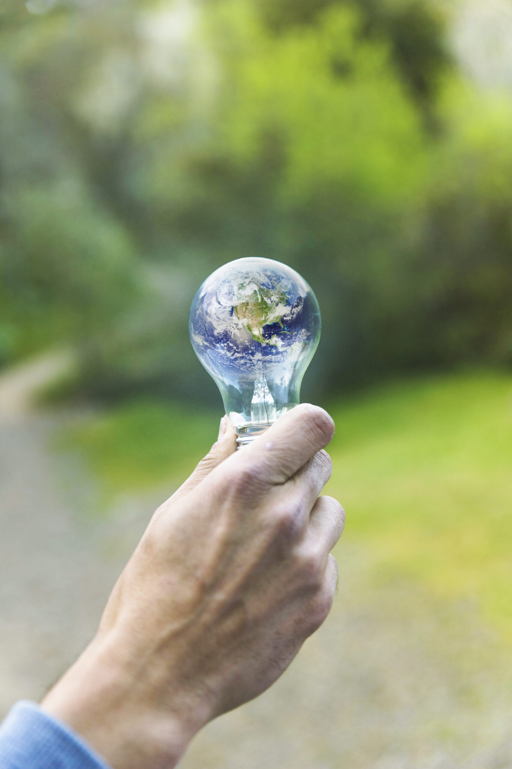 adult-arm-keeping-lamp-with-planet